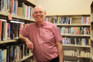 John Pateman standing with books